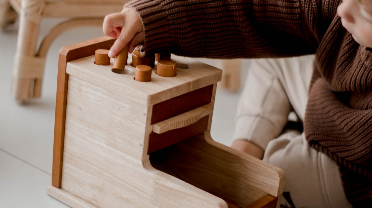 Child playing with wooden Montessori toy
