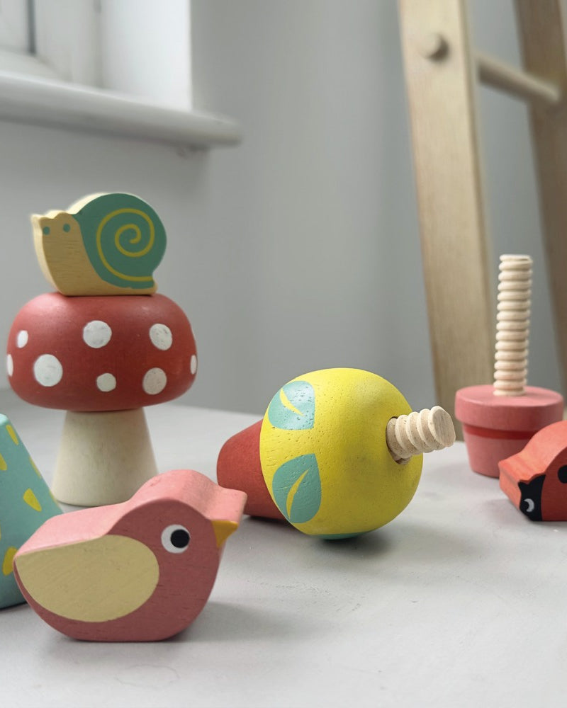 Set of colorful wooden toys on a white surface with a blurred background