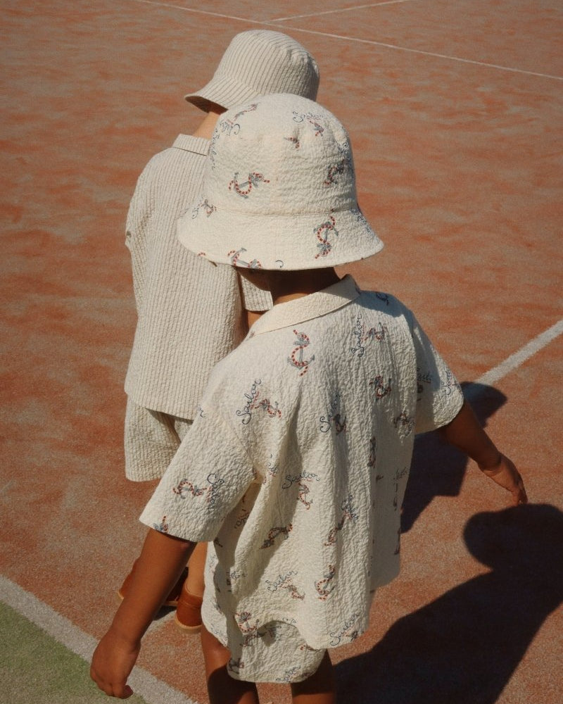 2 Boys Wearing a Bucket Hat in the Sun