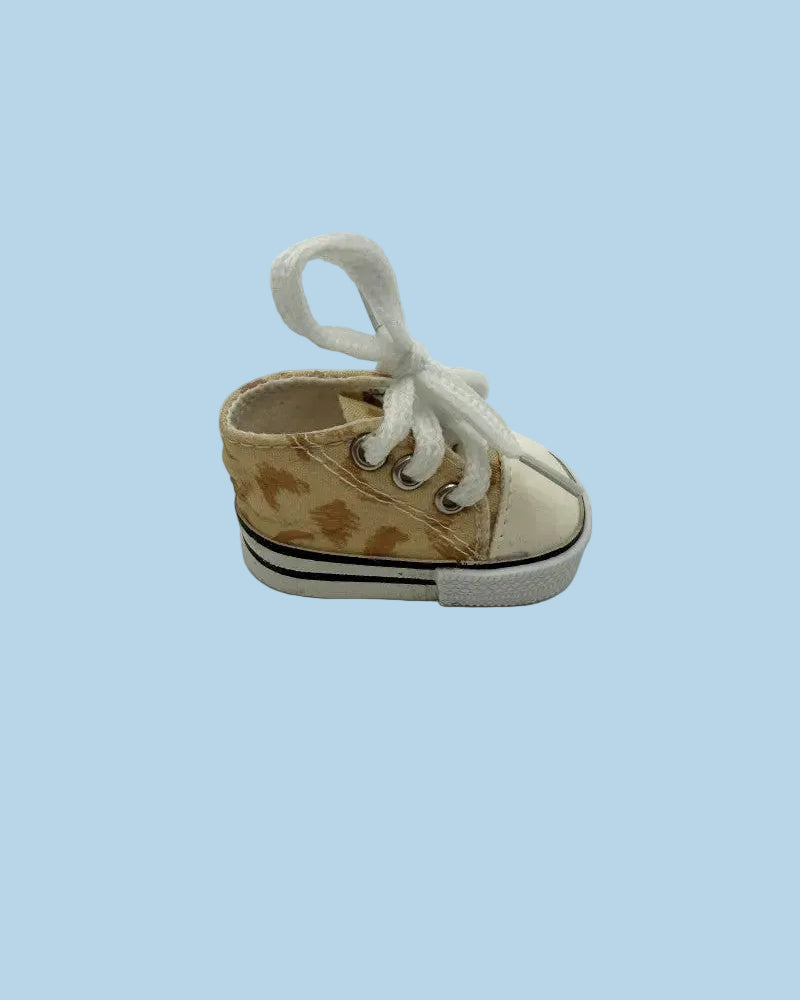 Small brown and white sneaker on a light blue background