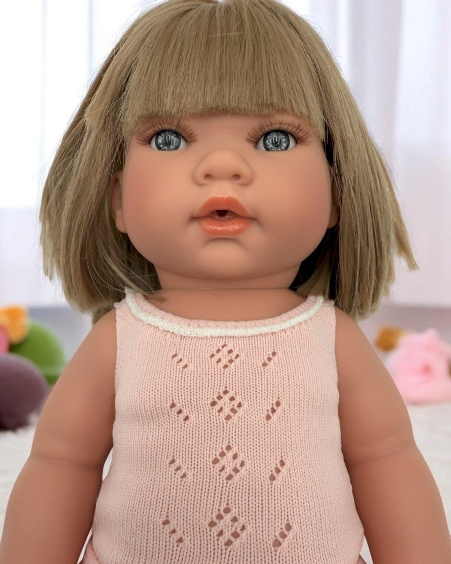 Close-up of Adelaide doll's lifelike face with striking blue eyes