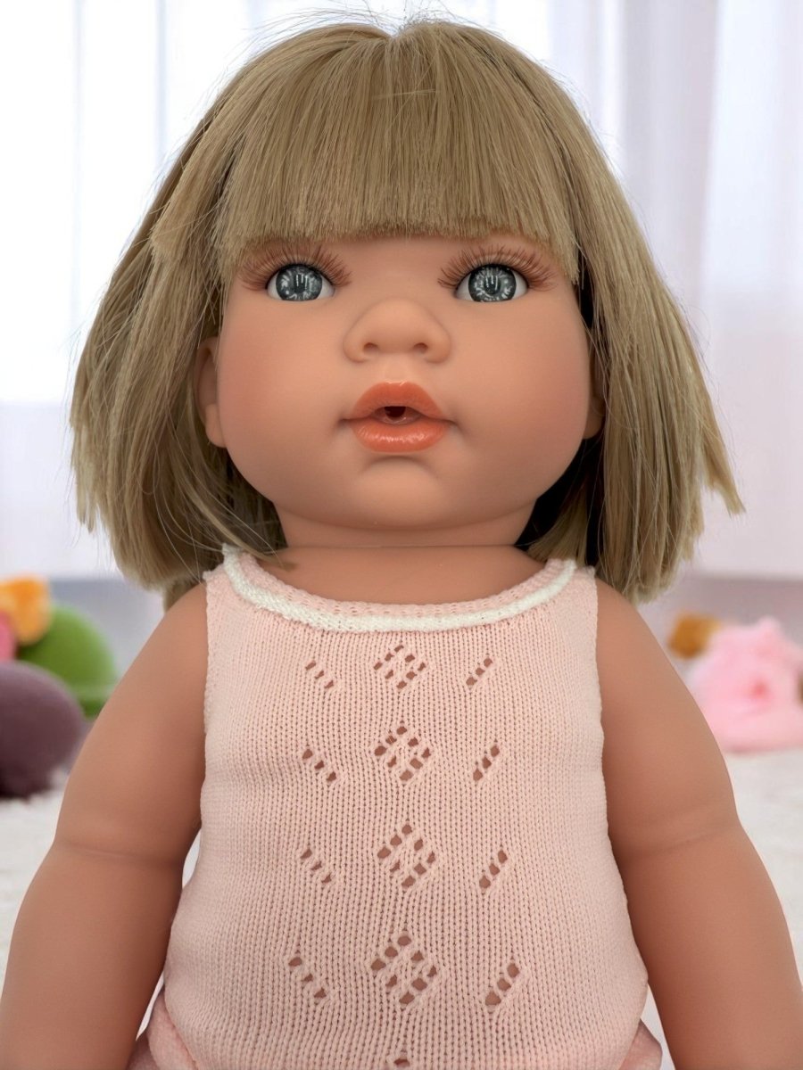 Close-up of Adelaide doll's lifelike face with striking blue eyes