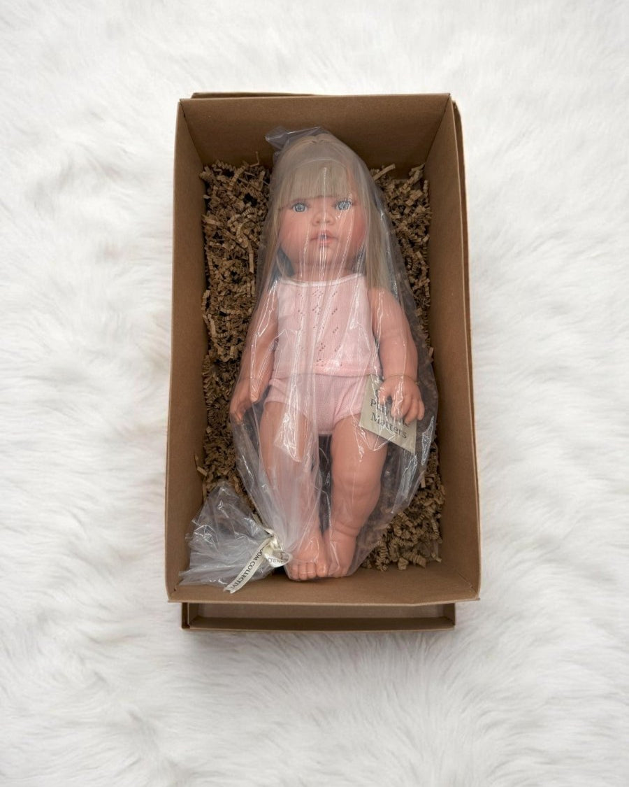 Fully clothed blonde hair blue eyes baby doll in white eyelet clothing