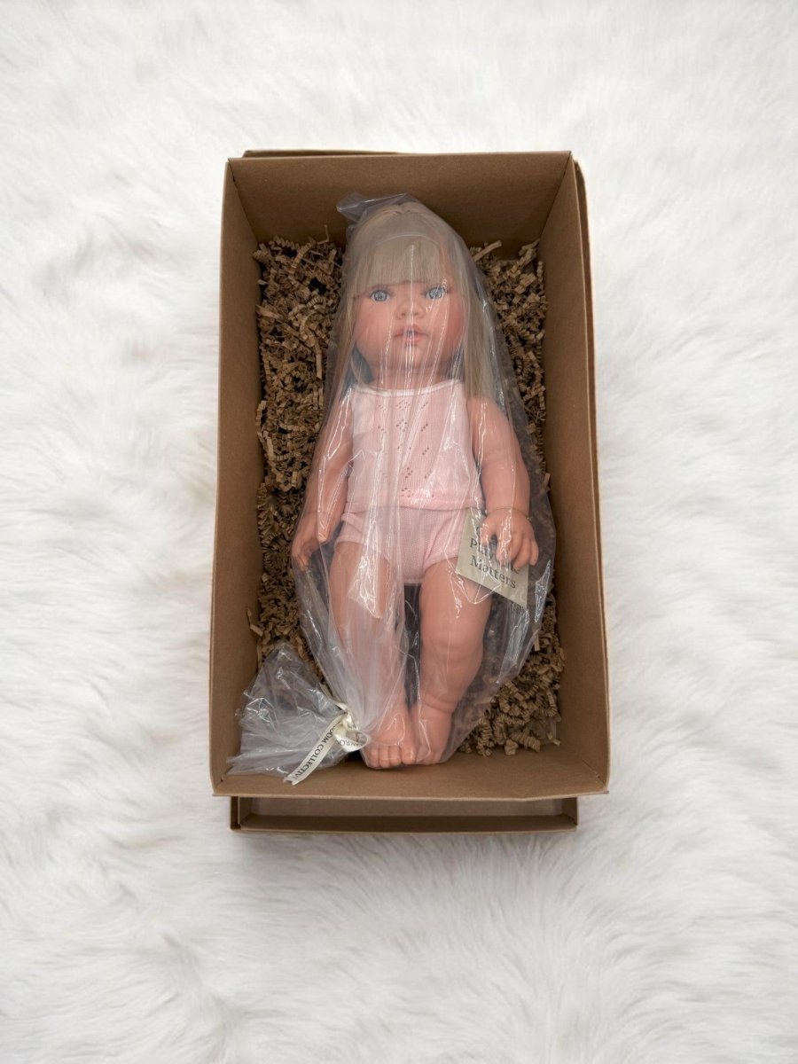 Fully clothed blonde hair blue eyes baby doll in white eyelet clothing