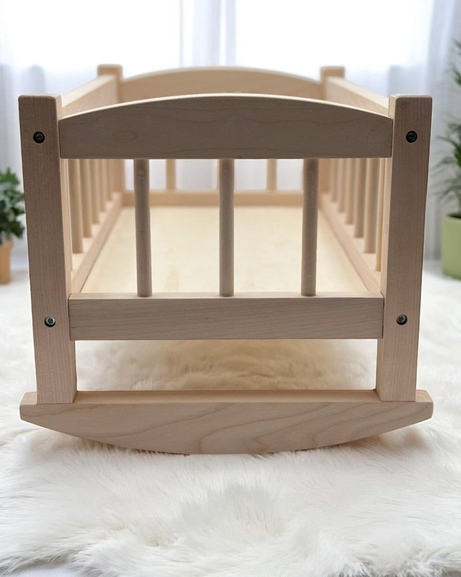 Heirloom quality wooden doll cradle with safety tested birch wood construction for nurturing play