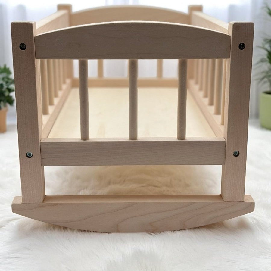 Heirloom quality wooden doll cradle with safety tested birch wood construction for nurturing play