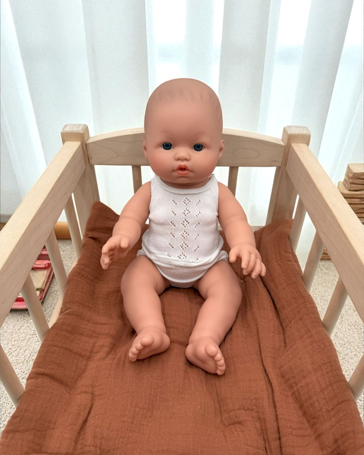 Blue-eyed realistic baby boy doll for developmental playroom activities