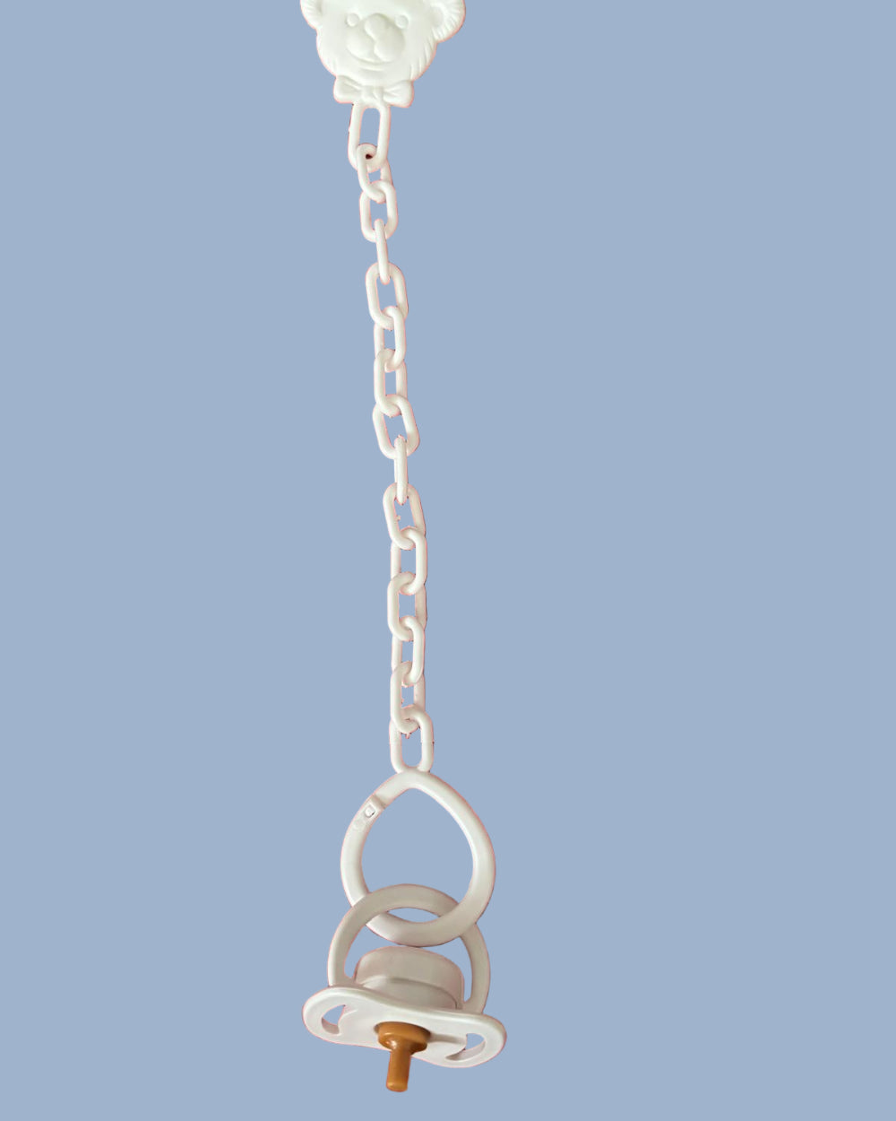 White pacifier on white chain