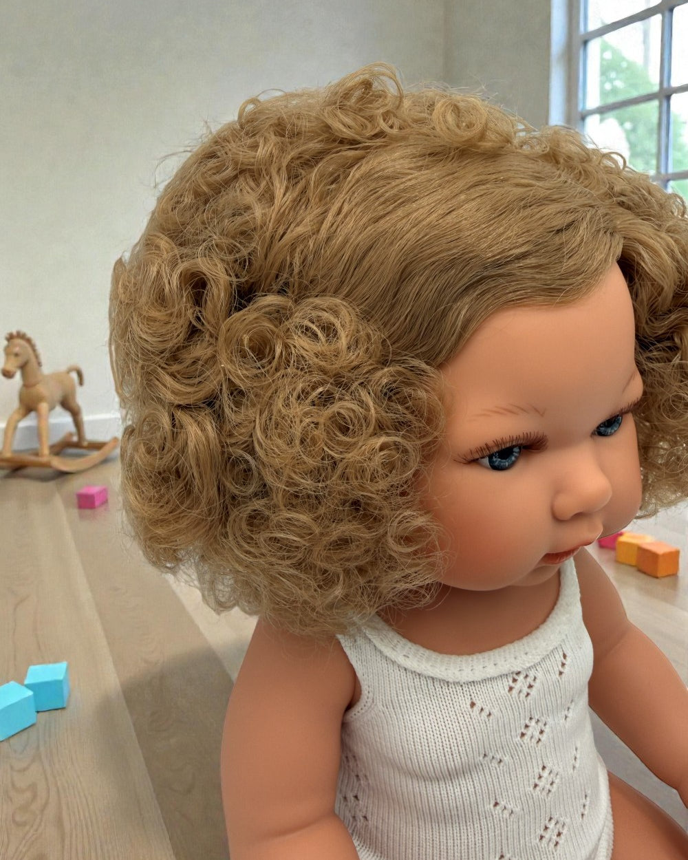 Premium European vinyl 13-inch doll with hand-painted features and curly hair texture