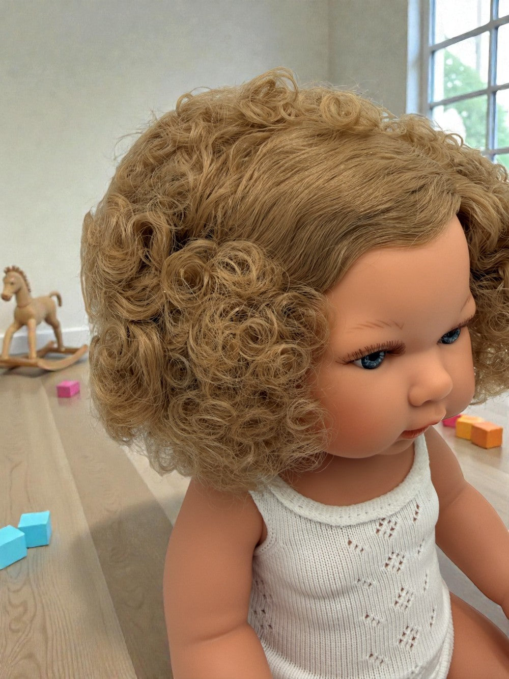 Premium European vinyl 13-inch doll with hand-painted features and curly hair texture