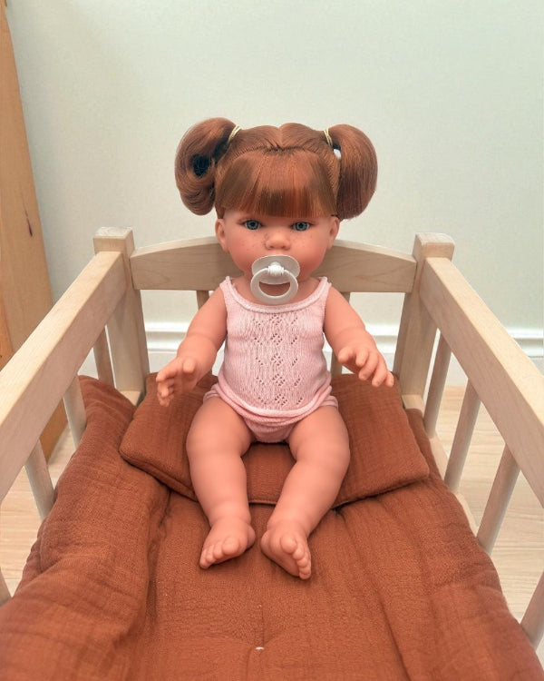 Realistic European-crafted baby girl doll with red ponytails and freckles