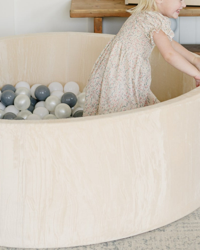 Child Grabbing Ball Pit