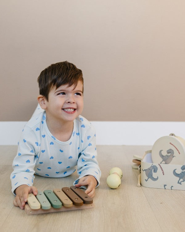 Child playing with a wooden toy on a wooden floor
