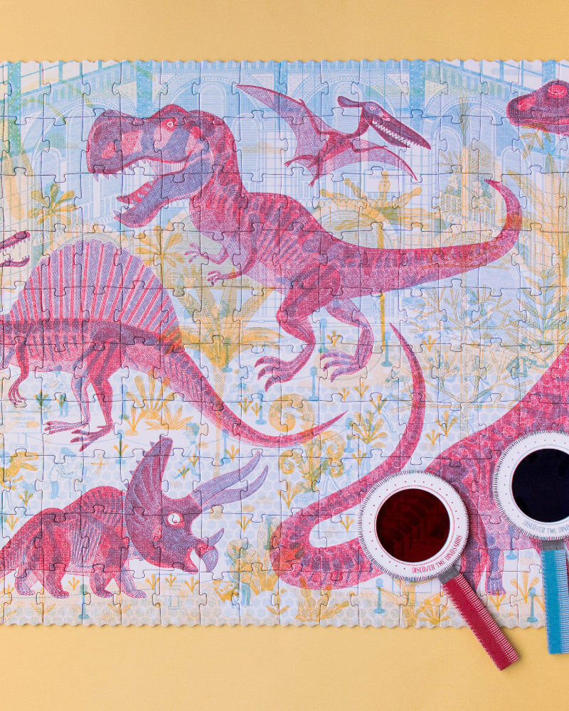 Dinosaur-themed puzzle on a yellow background with two cups and a straw.