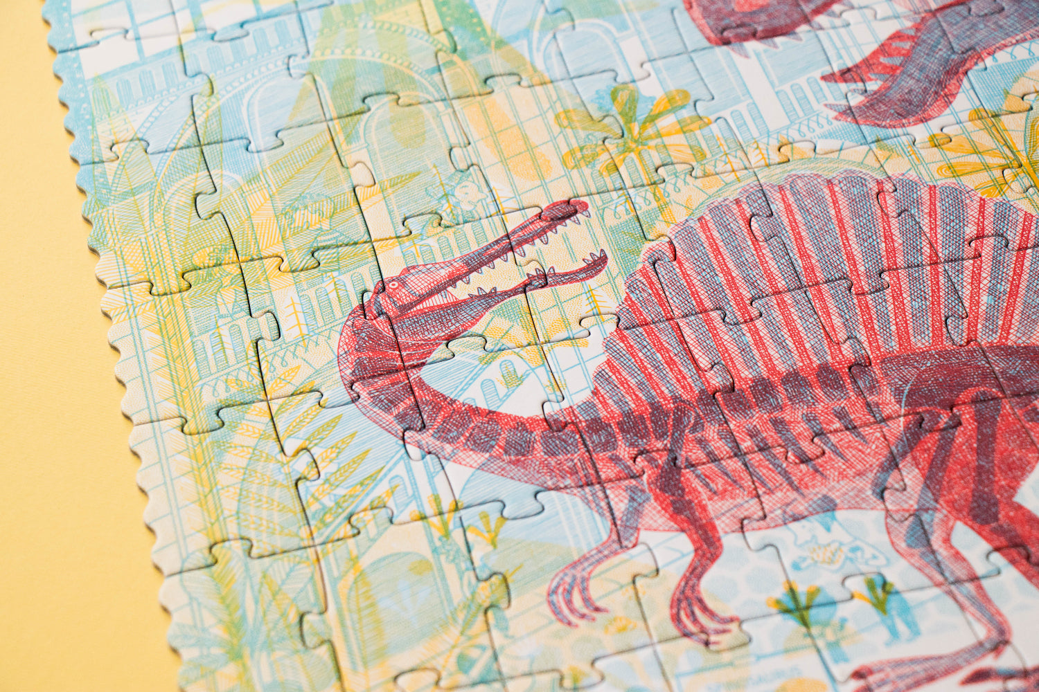 Dinosaur-themed puzzle with a partially completed design on a yellow background