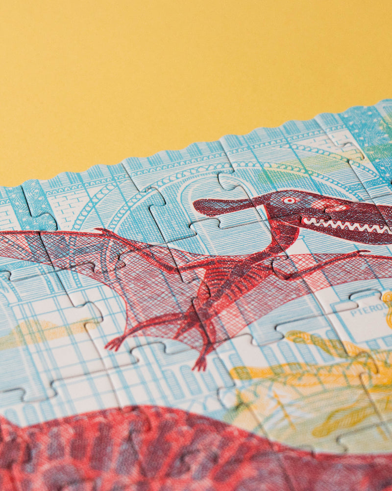 Jigsaw puzzle with dinosaur design on a yellow background