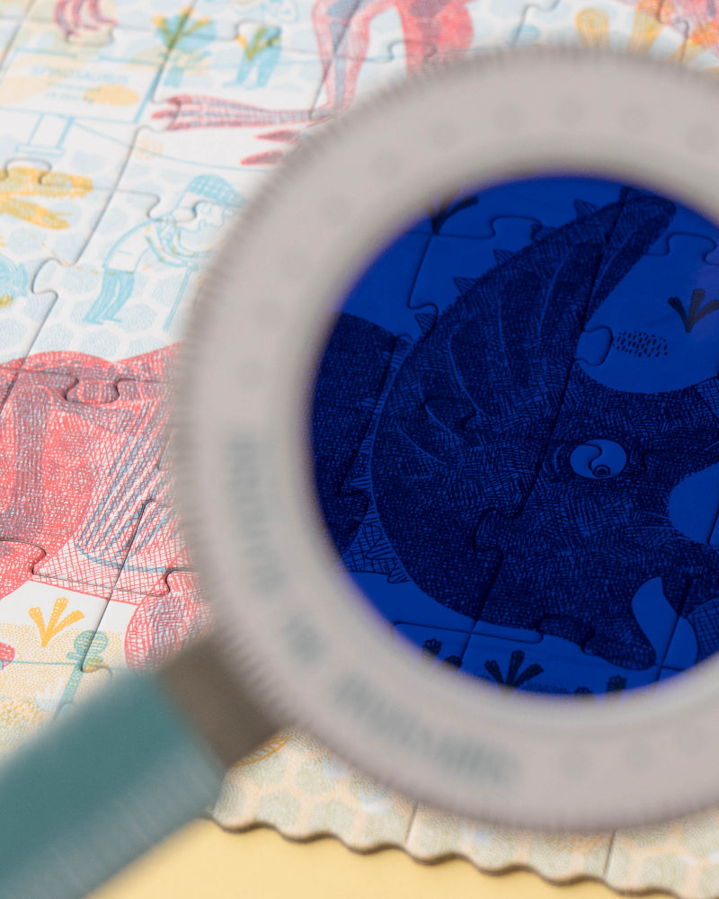 Magnifying glass over a colorful puzzle with a blue section