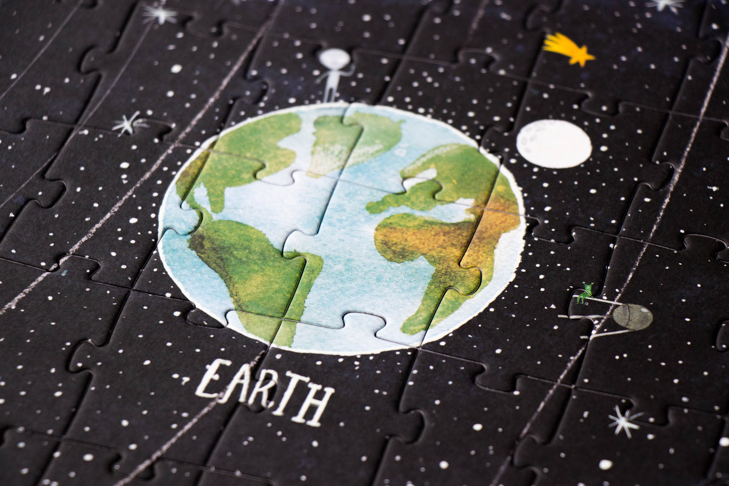 Jigsaw puzzle piece with Earth illustration on a space-themed background