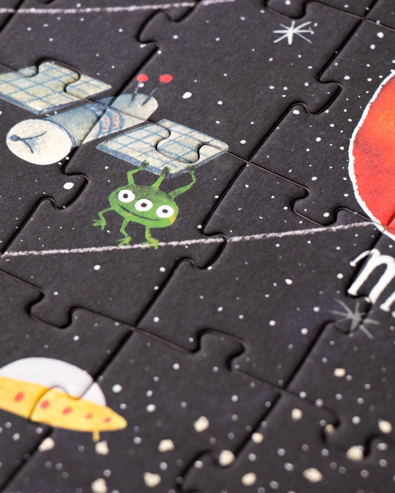 Space-themed puzzle with illustrations of a spacecraft, alien, and UFO on a black background with white dots.