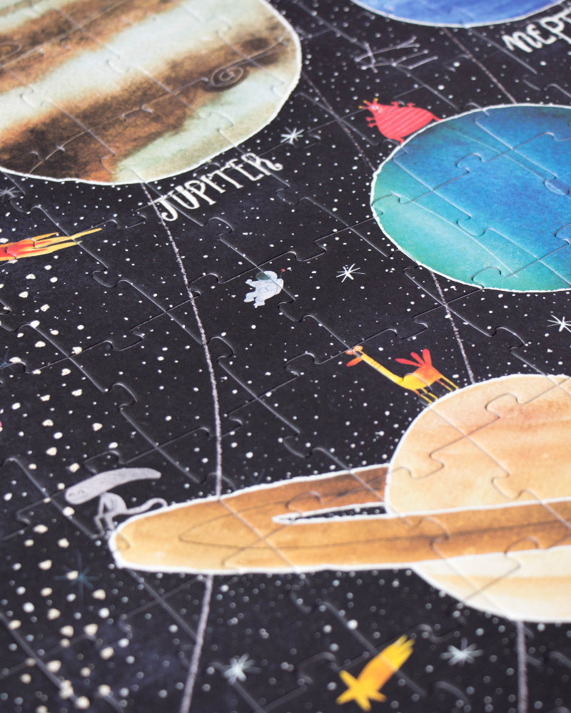 Children's space-themed puzzle with illustrations of planets and stars on a dark background.