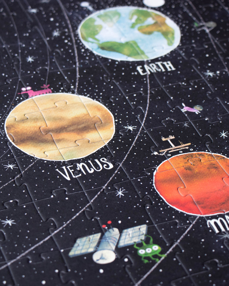 Solar system-themed puzzle with planets and stars on a dark background