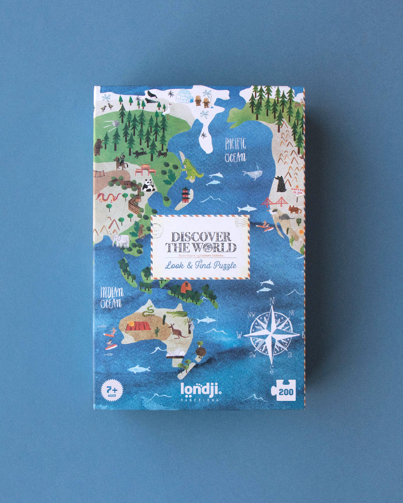 Jigsaw puzzle box with world map design on a blue background