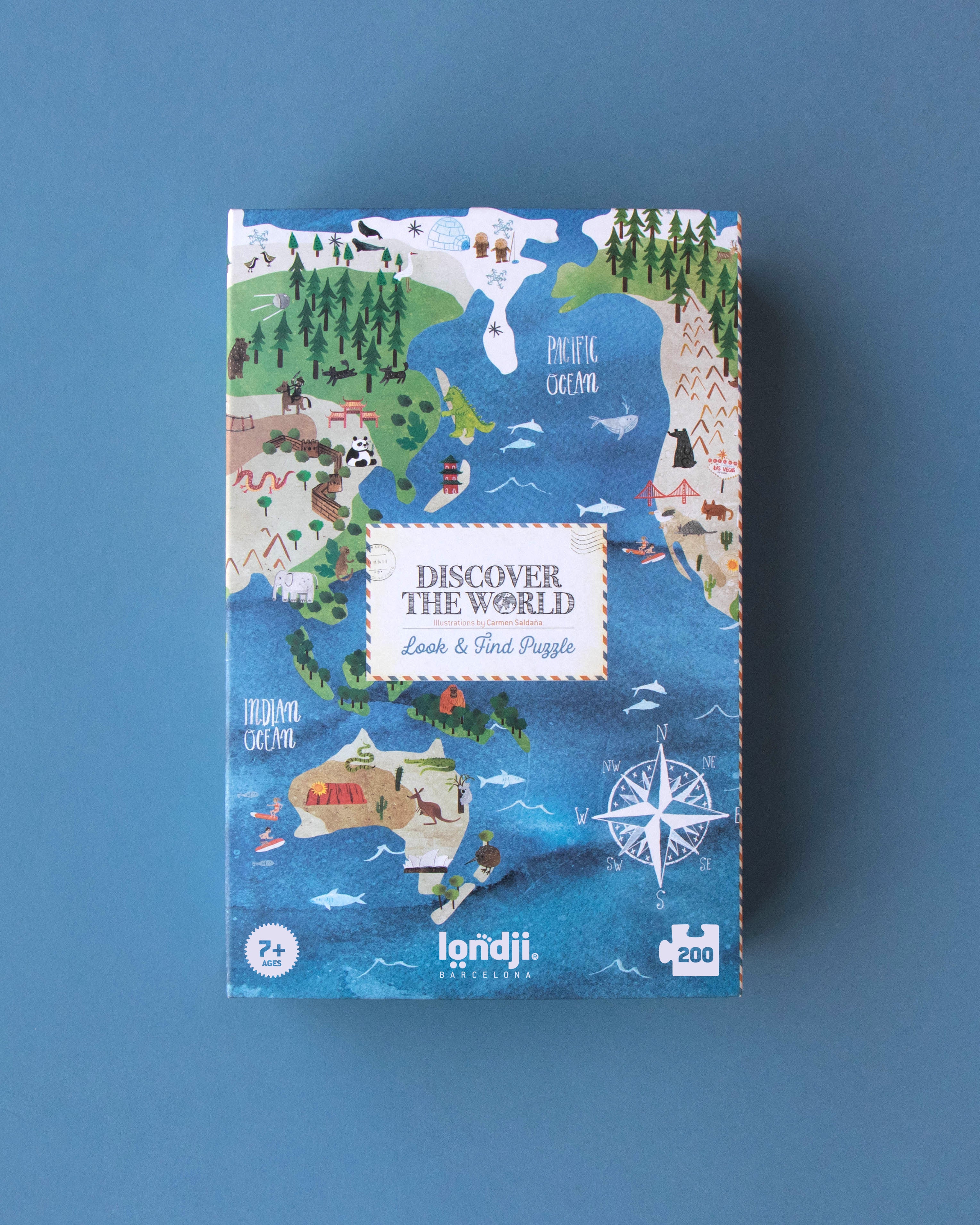 Jigsaw puzzle box with world map design on a blue background