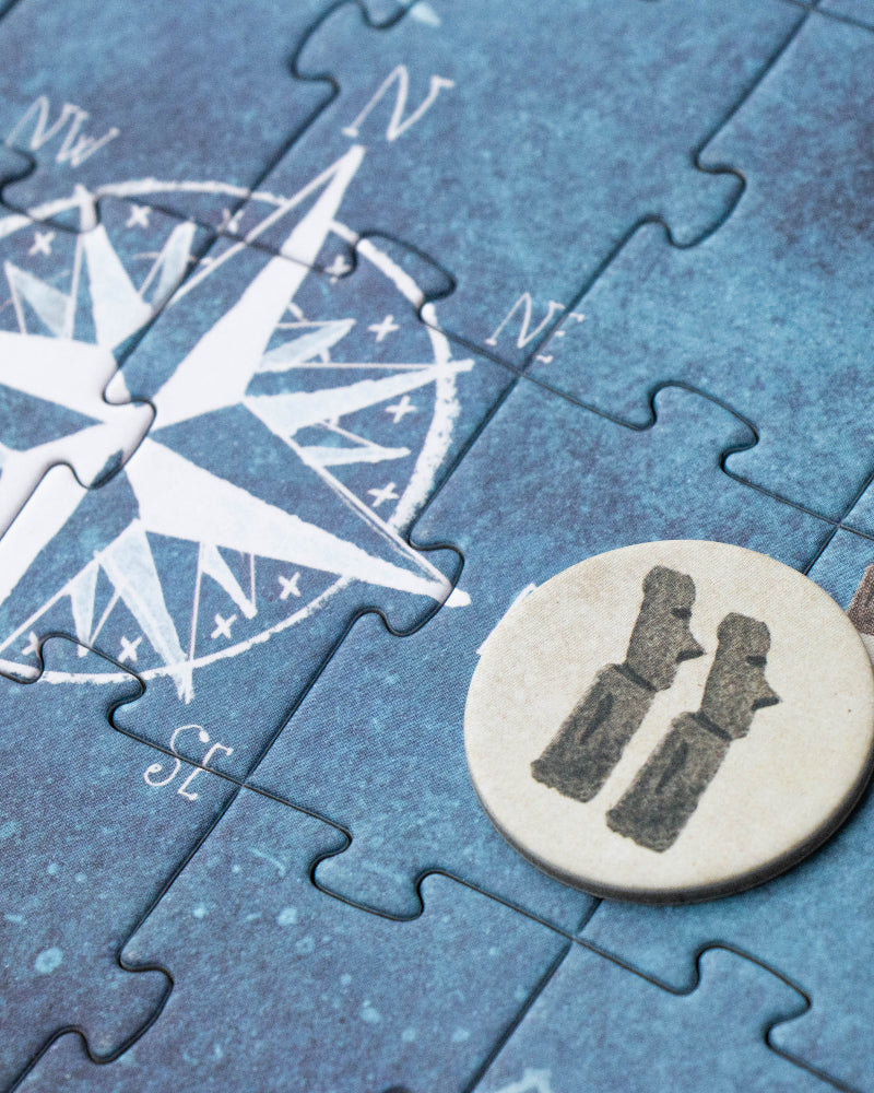 Jigsaw puzzle with a compass and map design on a blue background