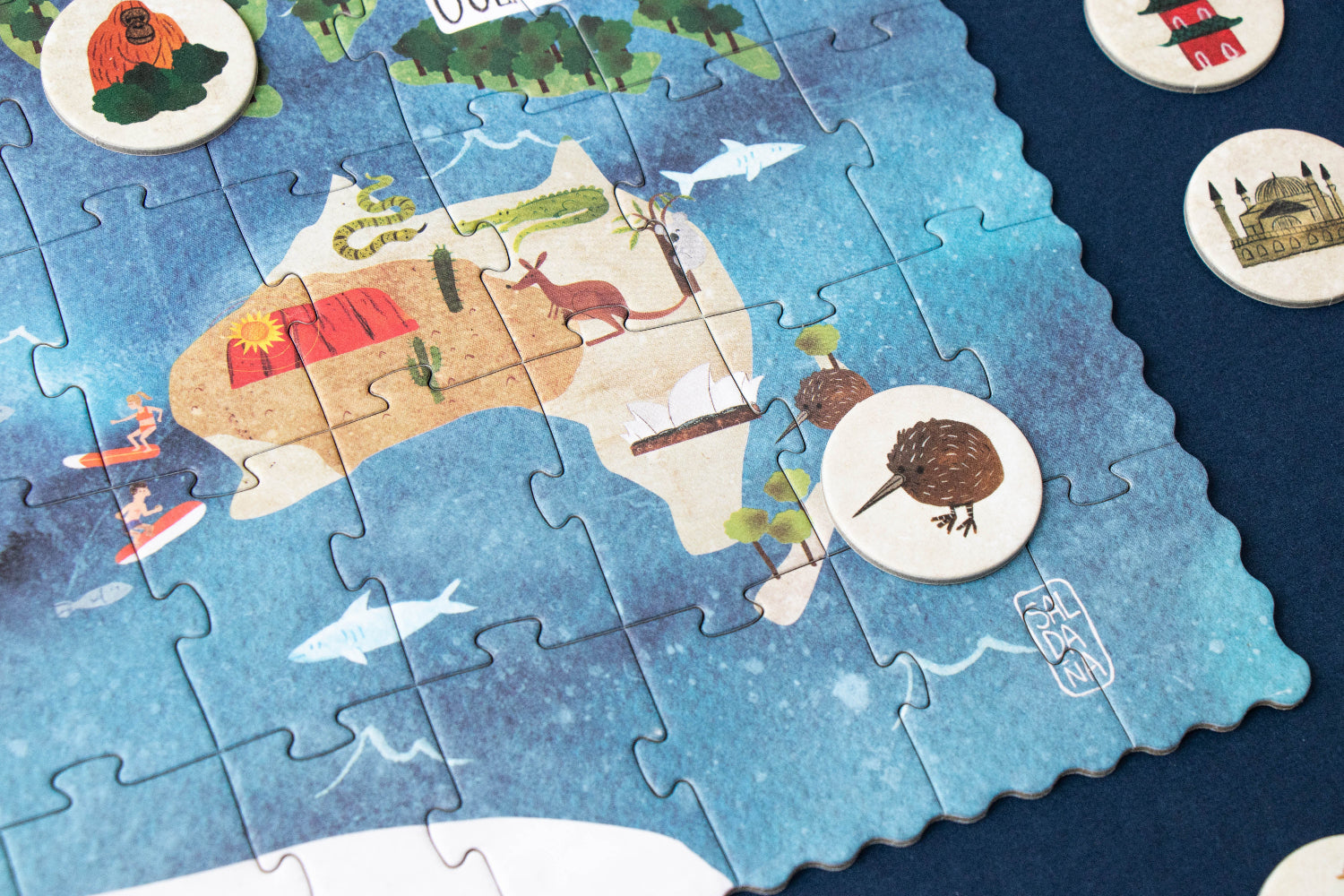 Jigsaw puzzle of Australia with completed pieces and missing ones on a blue background