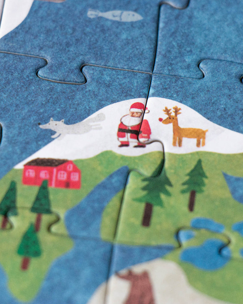 Children's puzzle with a Santa Claus and reindeer design on a blue background