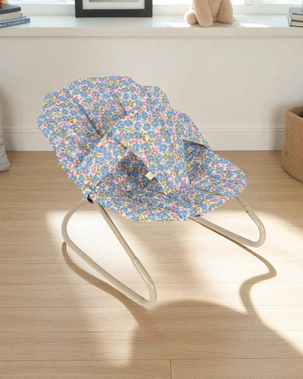 Fleur Rosier doll bouncer with blue floral print fabric seat featuring botanical garden design and champagne metal frame