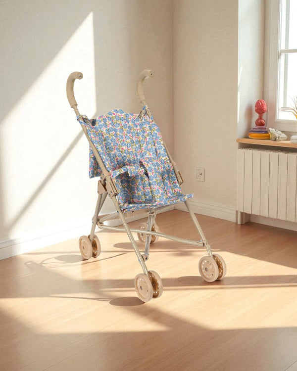 Full Fleur Rosier doll stroller with blue floral fabric, champagne frame and four-wheel mobility system for smooth rolling