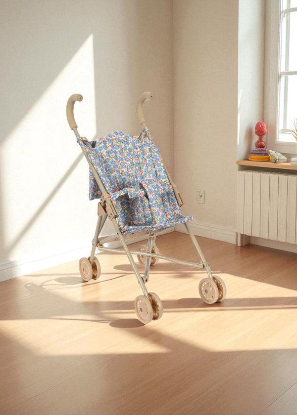 Full Fleur Rosier doll stroller with blue floral fabric, champagne frame and four-wheel mobility system for smooth rolling