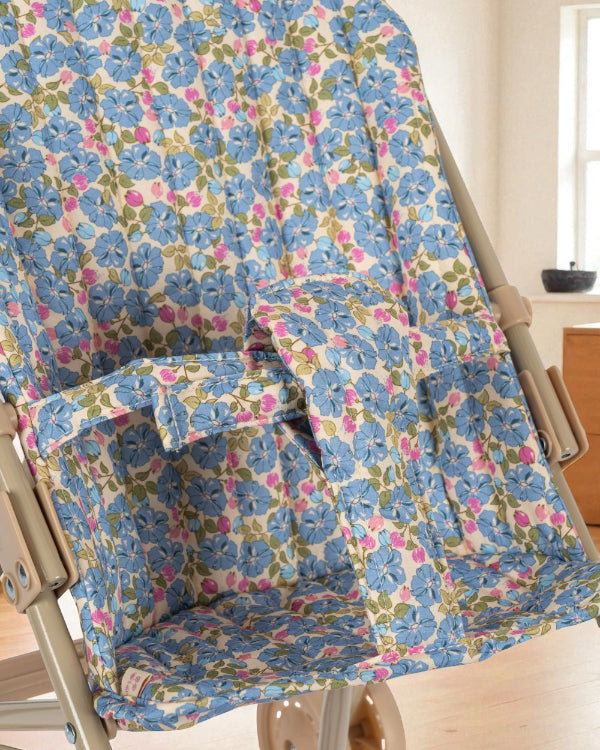 Secure fabric harness system in coordinating Fleur Rosier print ensuring safe doll positioning during stroller play