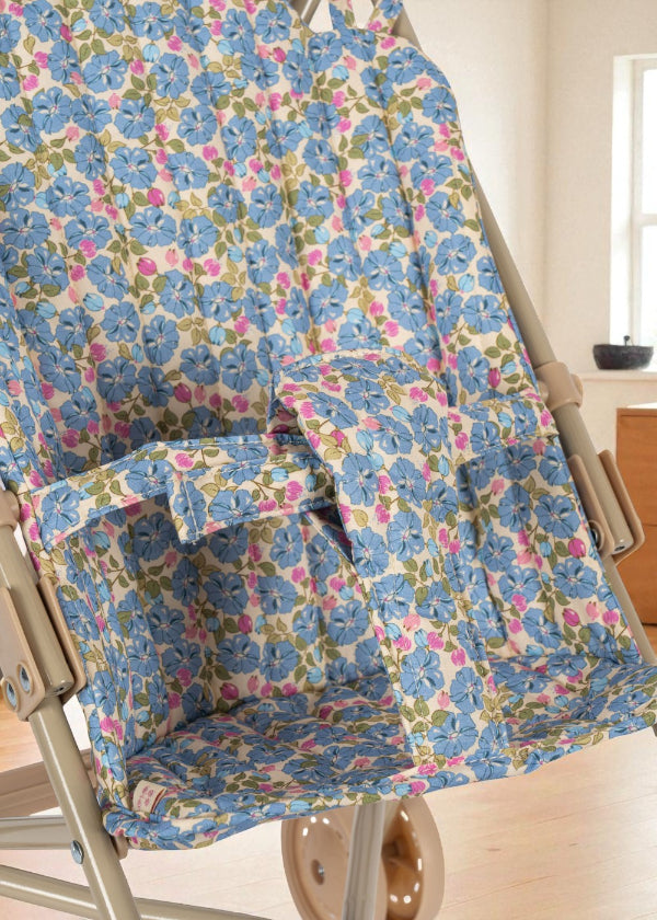 Secure fabric harness system in coordinating Fleur Rosier print ensuring safe doll positioning during stroller play