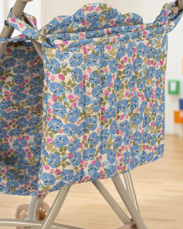 Close-up of Fleur Rosier print stroller hood showing cornflower blue flowers with pink and green accents on premium cotton