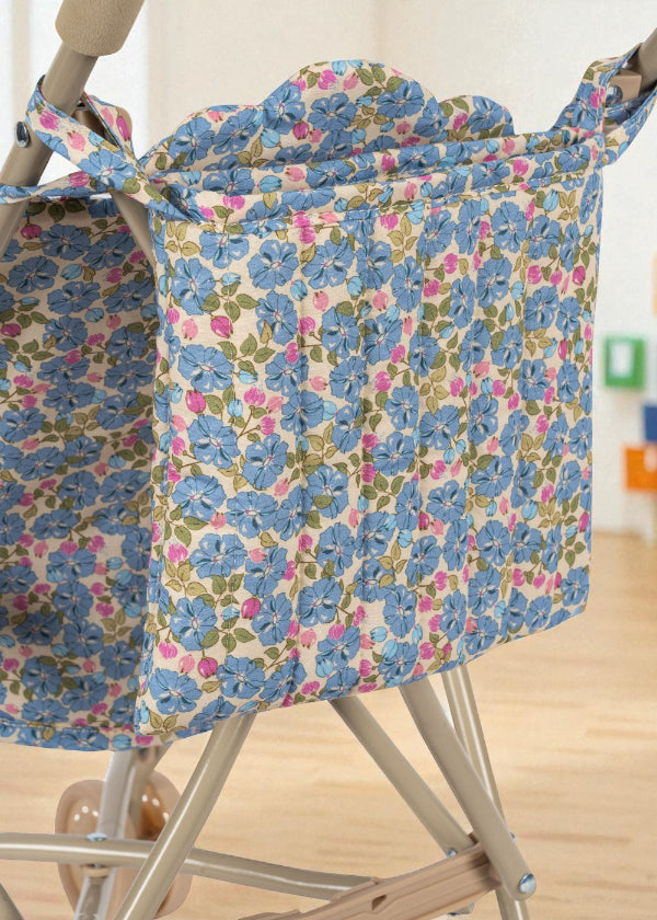 Close-up of Fleur Rosier print stroller hood showing cornflower blue flowers with pink and green accents on premium cotton