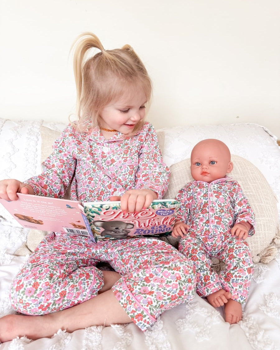 Girl and doll wearing floral pajamas