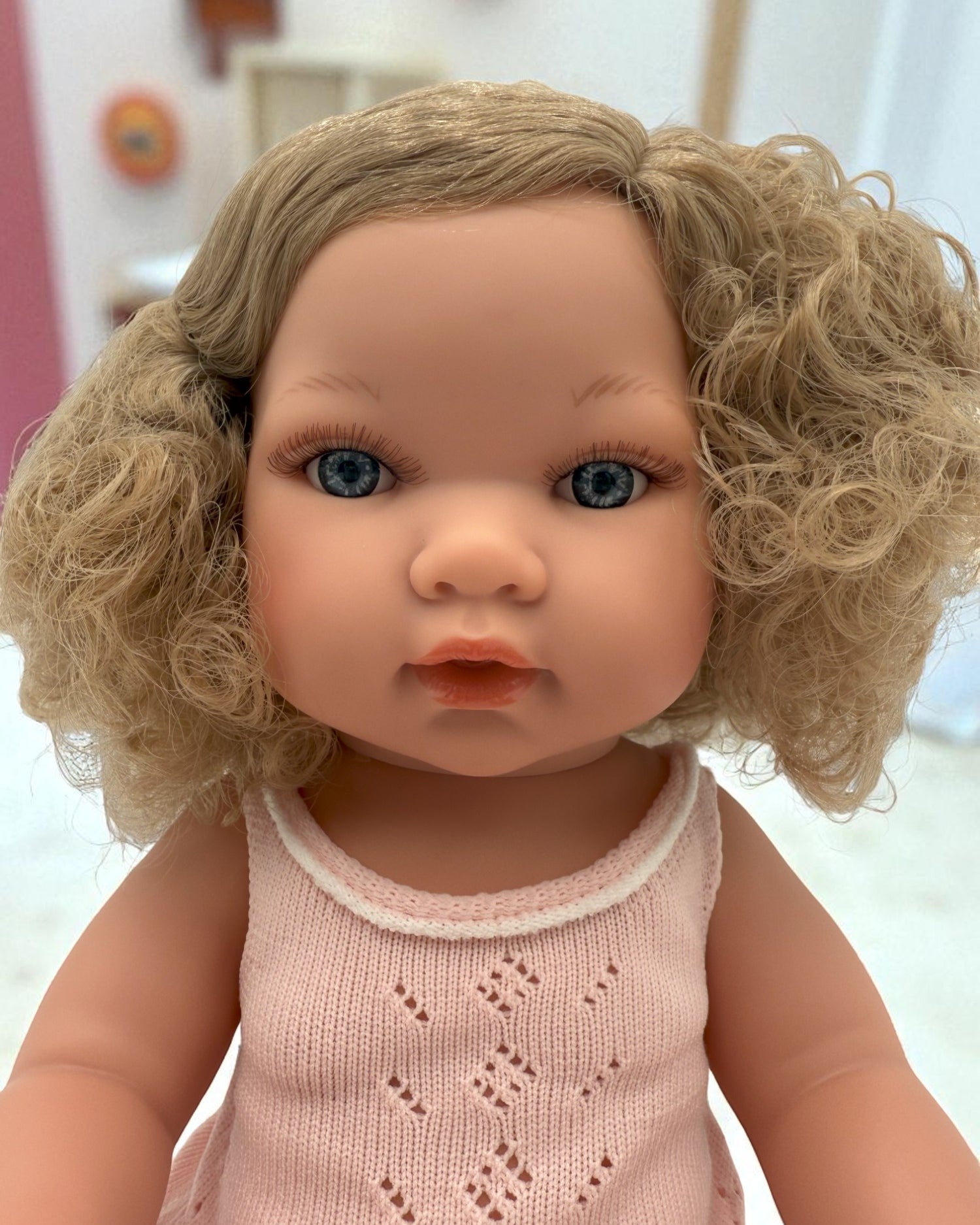 Close-up of Florence doll's lifelike face with bright blue eyes