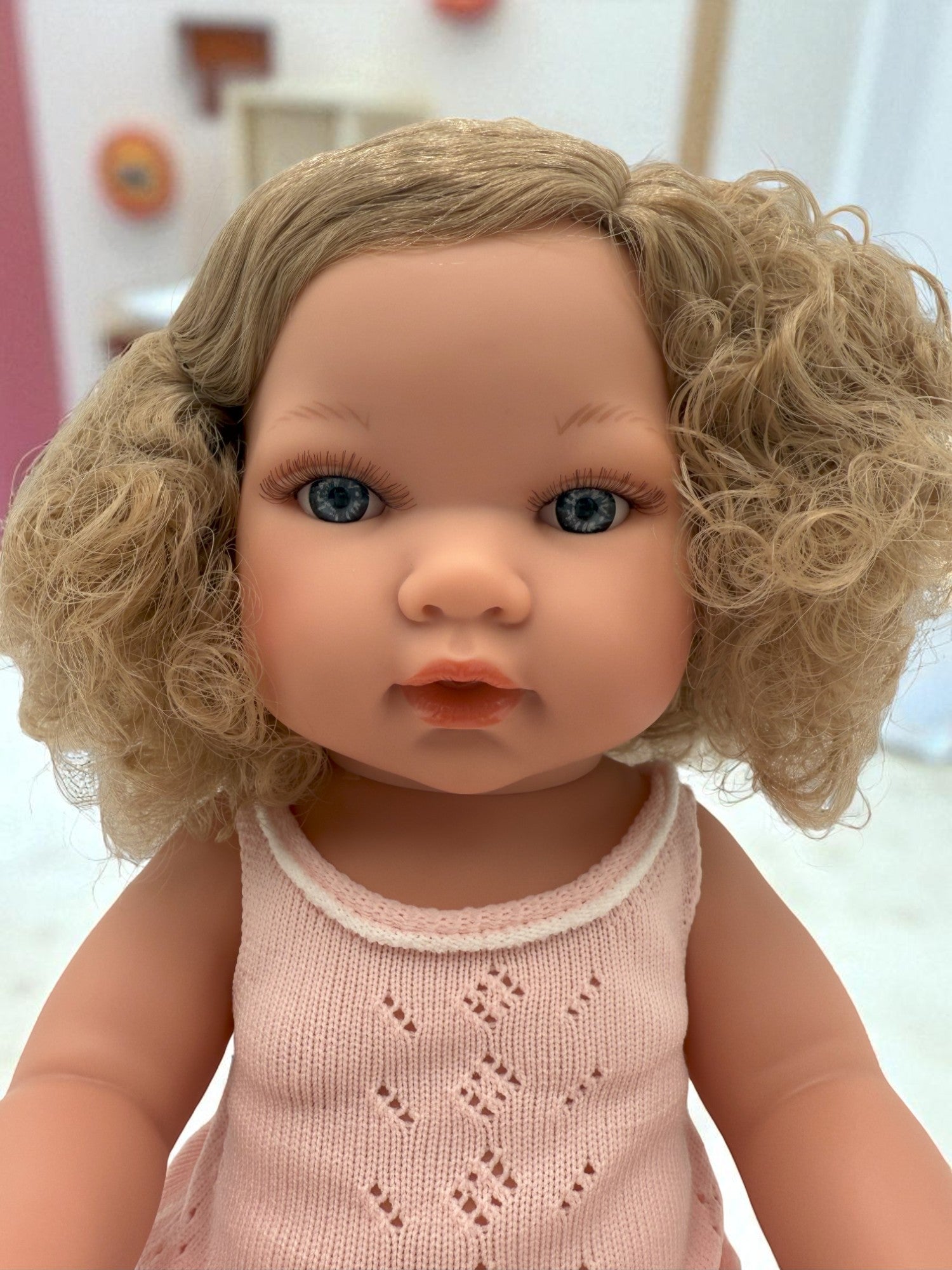 Close-up of Florence doll's lifelike face with bright blue eyes