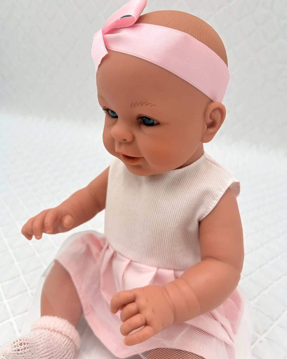 European-quality 18" girl doll in pink dress and white ribbed top with satin ribbon