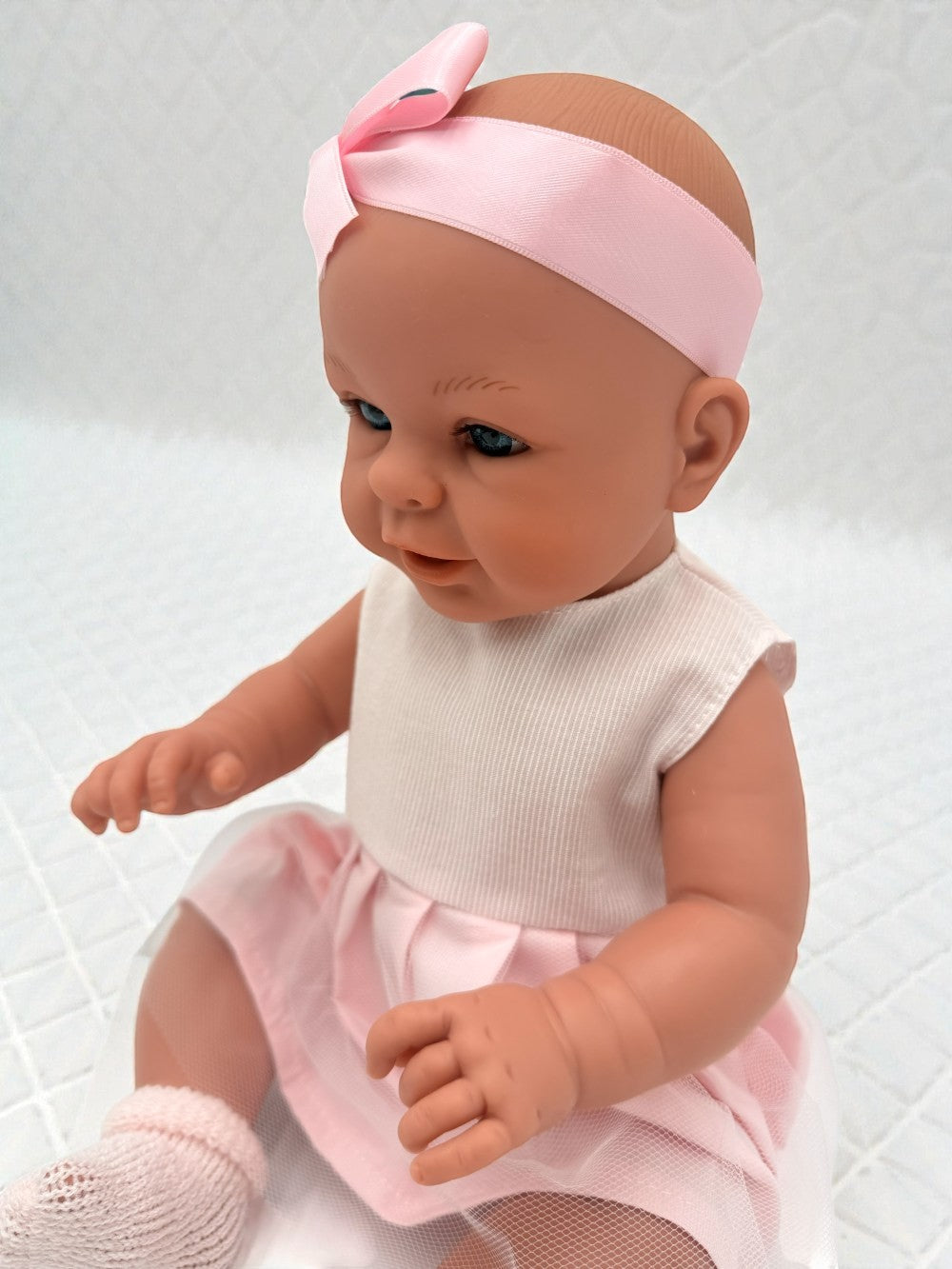European-quality 18" girl doll in pink dress and white ribbed top with satin ribbon