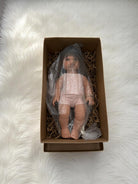 Realistic doll Milan with brunette straight hair wearing pink ribbed pajama set for screen-free play