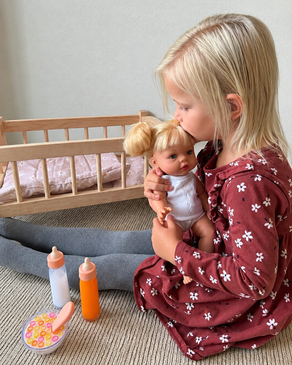 Girl kissing doll