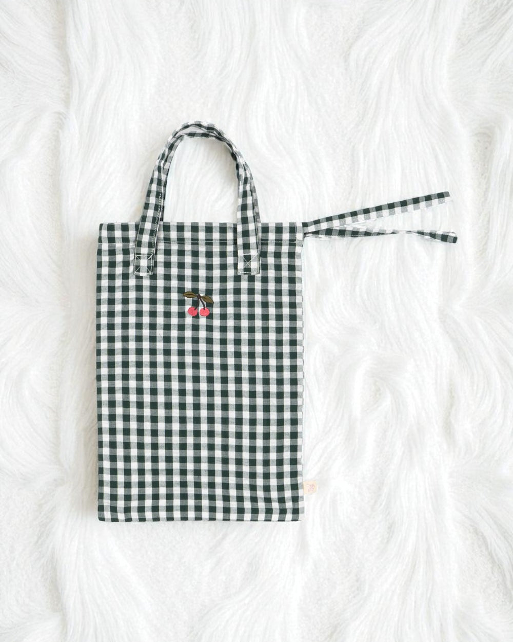 Premium construction detail showing button-tufted craftsmanship of green check doll bedding set