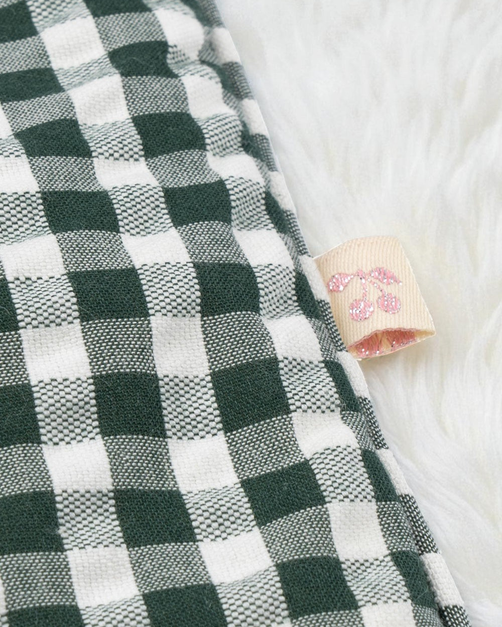 Matching green gingham pillow with plush filling showing quality construction and country cottage pattern detail