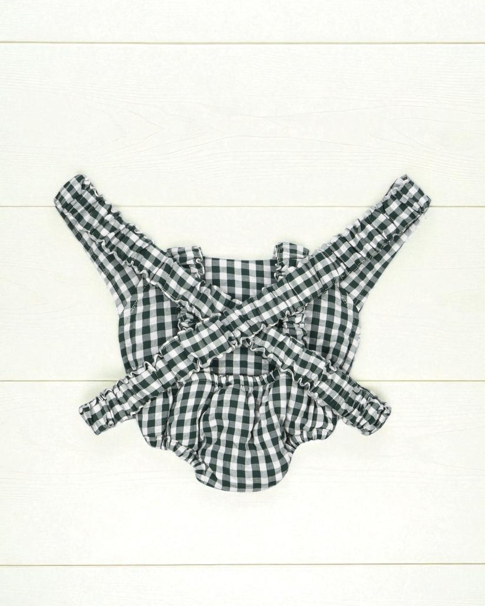 Back view of green gingham doll carrier showing comfortable strap system and complete pattern coverage