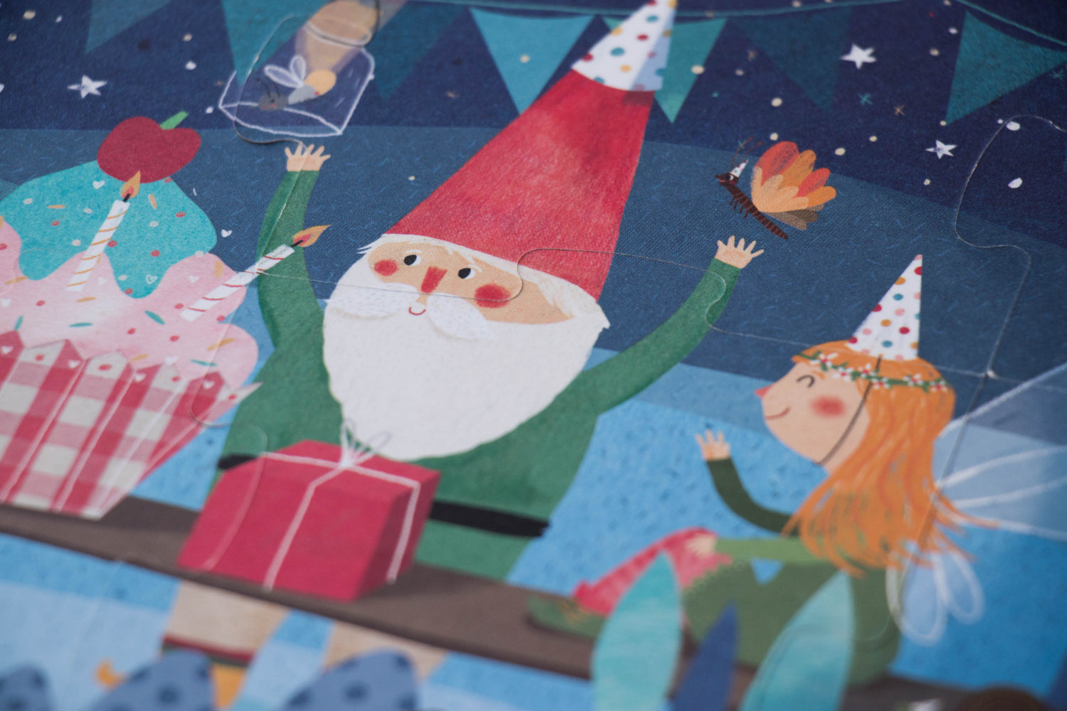 Illustration of a gnome and fairy with a cake and presents on a festive background