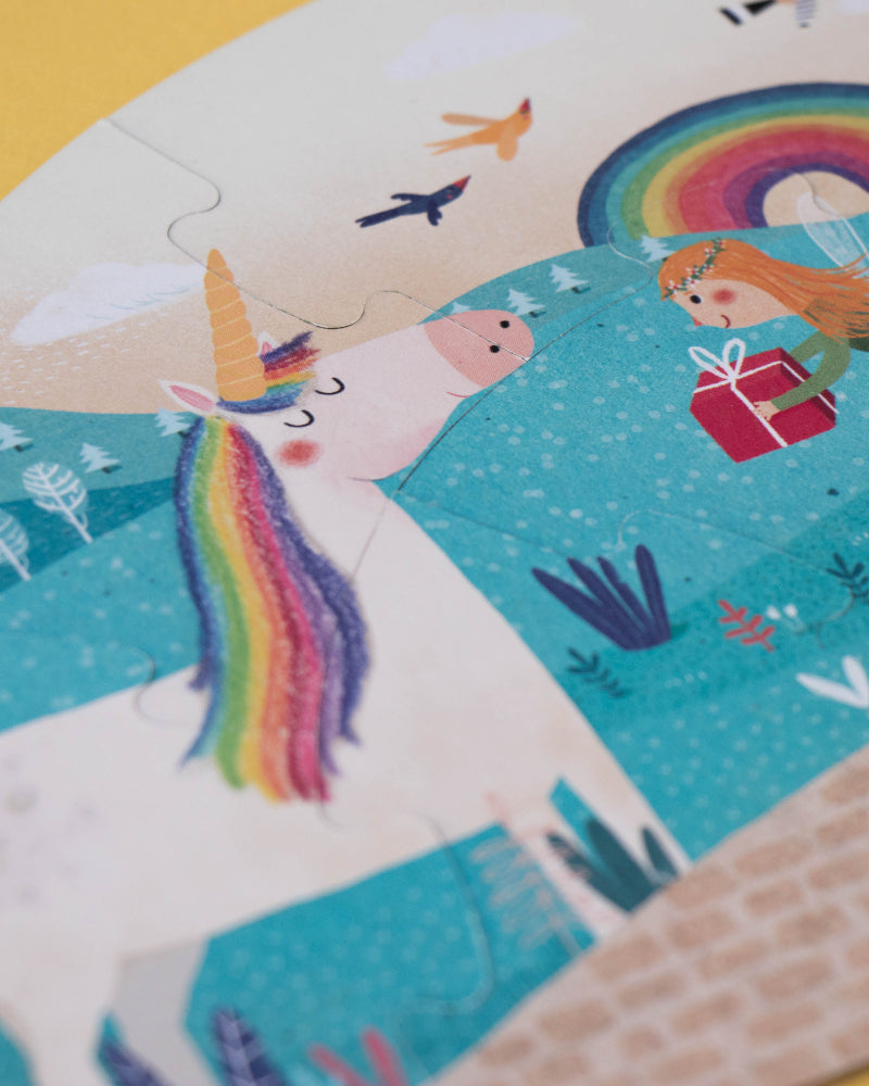Children's puzzle with a unicorn and fairy design on a yellow background