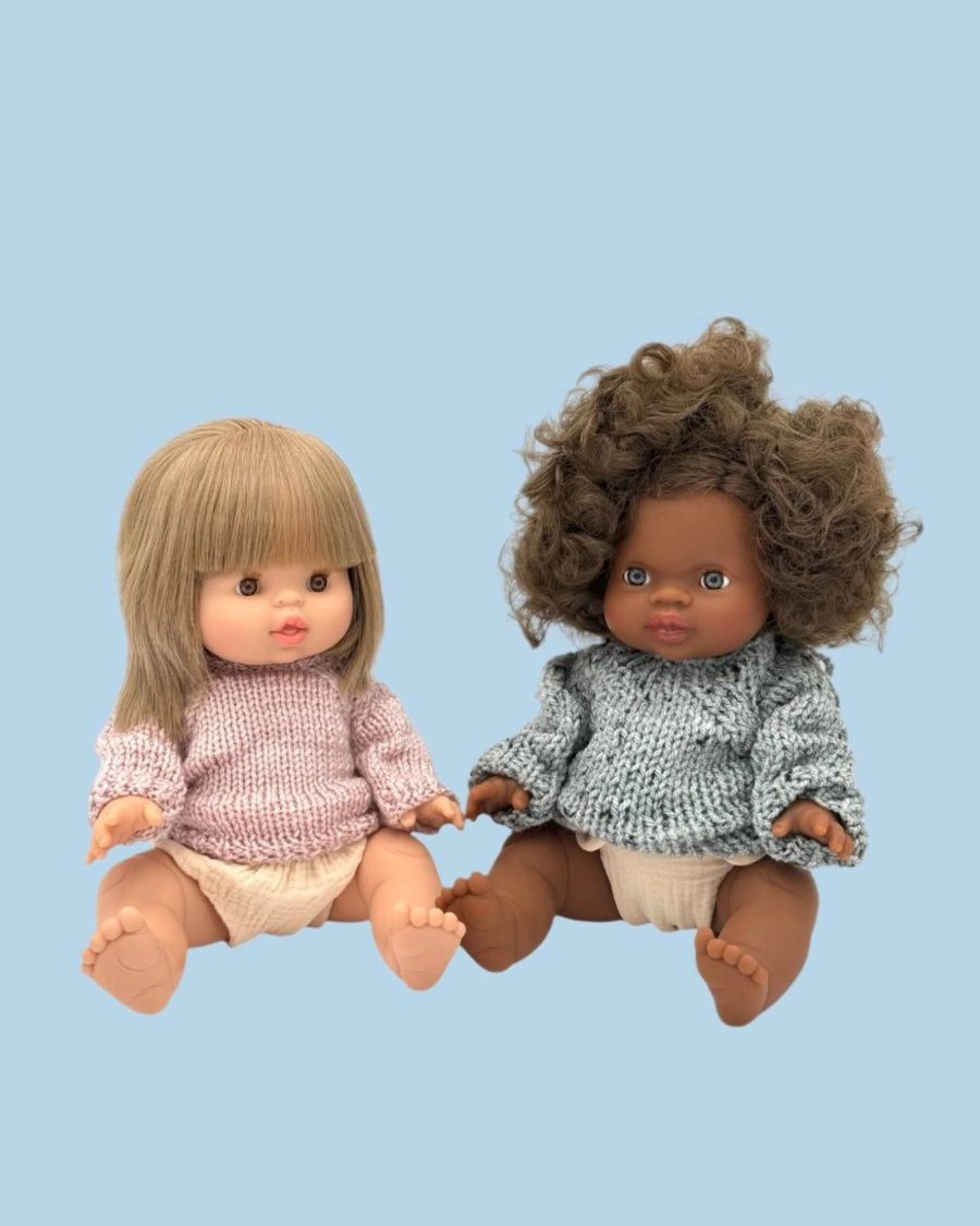 Twin dolls coordinating wardrobe with complementary styles